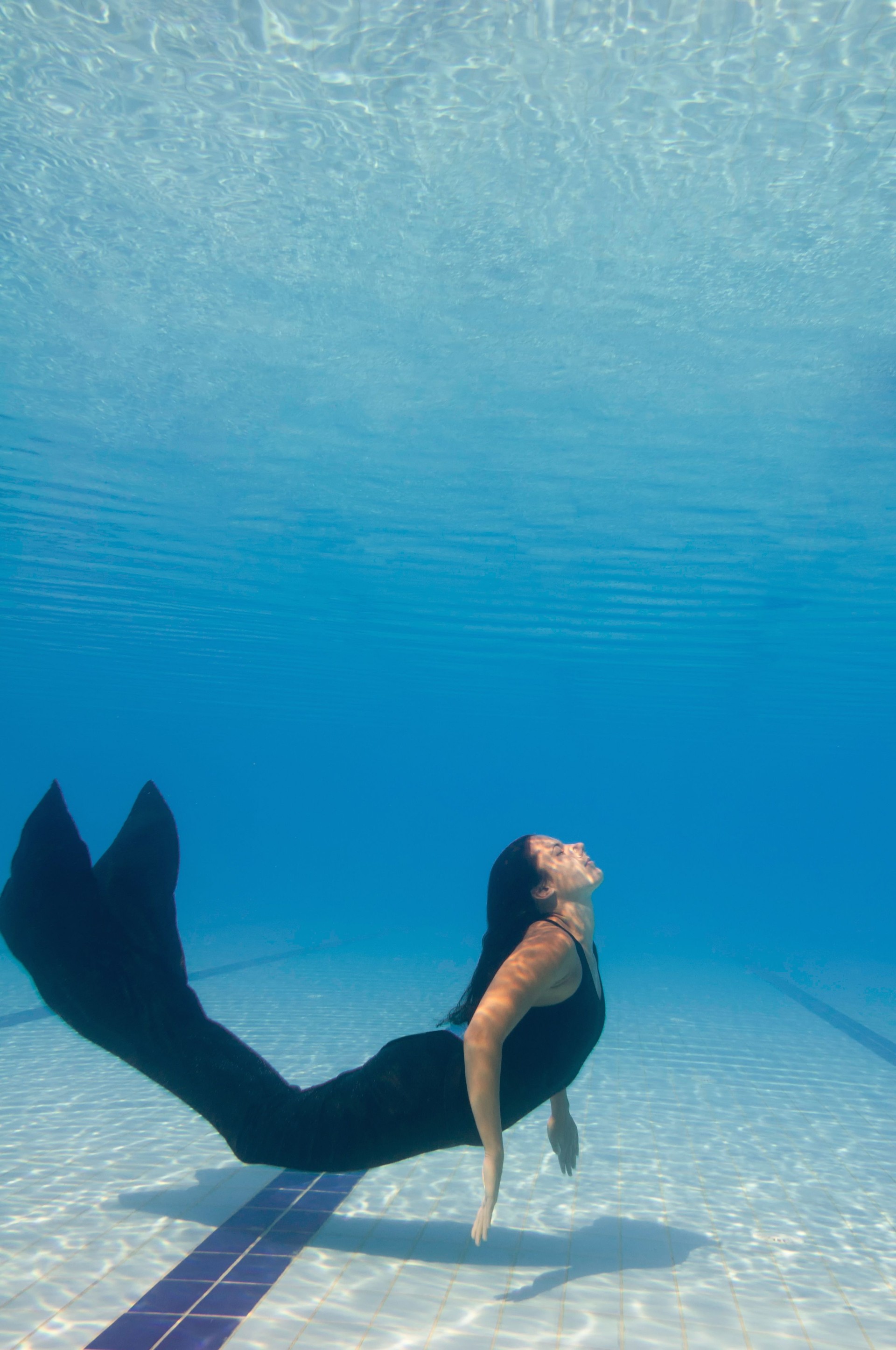 Female Model Swimming In Pool